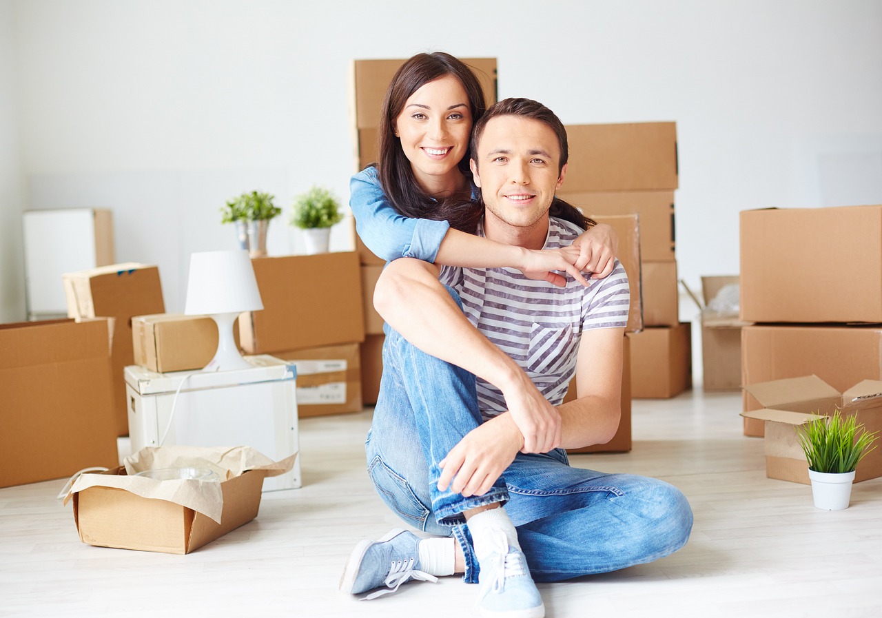 couple unpacking boxes after moving